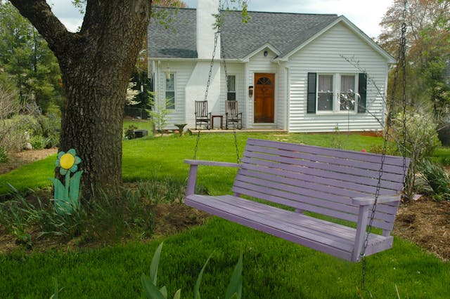 house with swing bench in garden