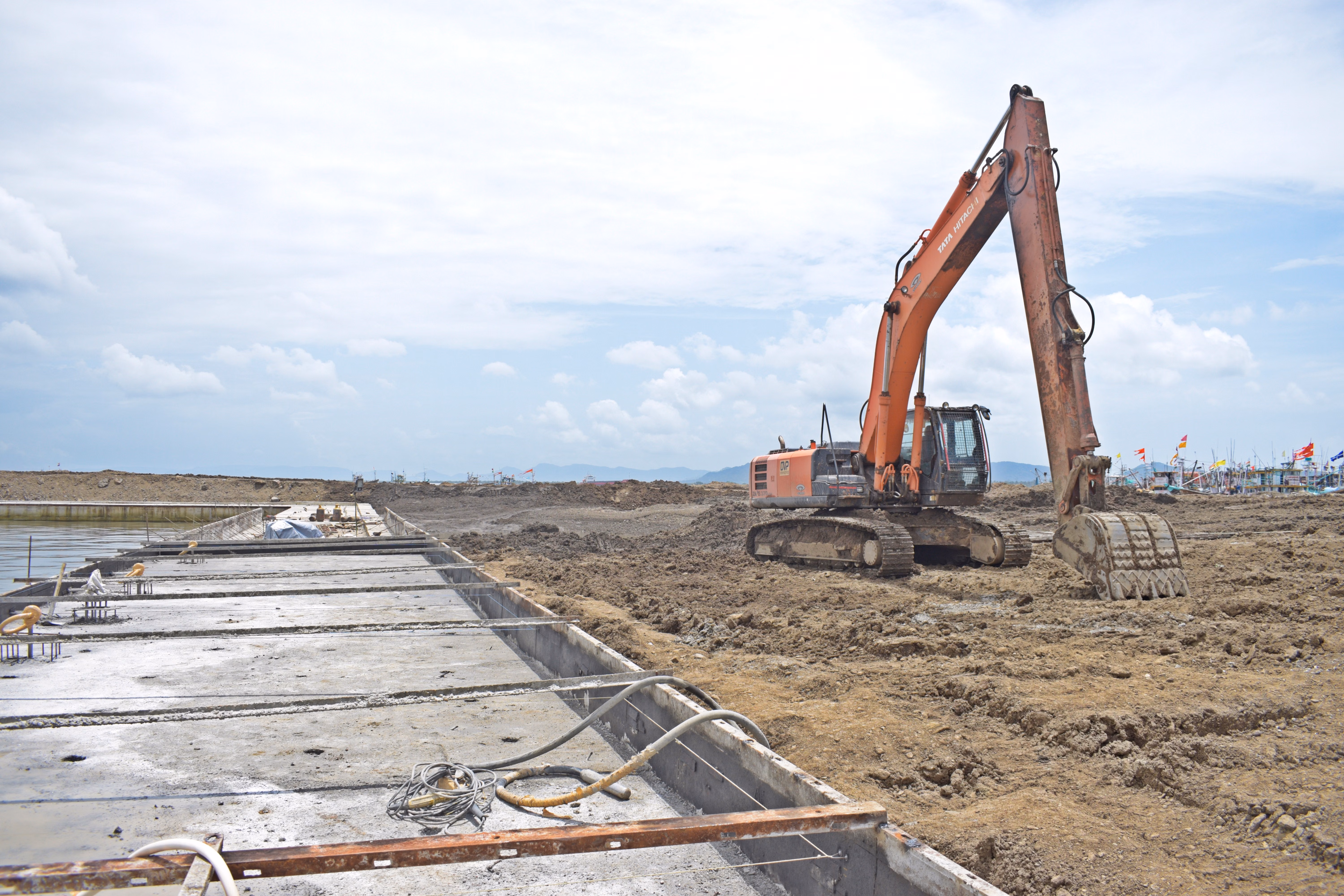 Excavator grading a building pad for new home foundation