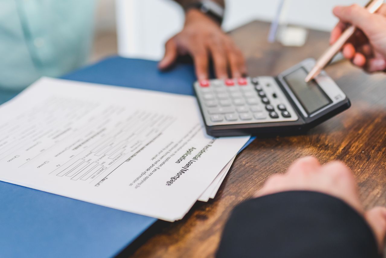 Mortgage agreement and calculator on a desk