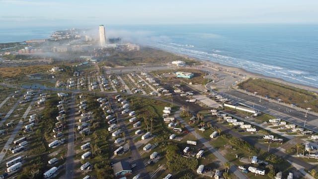 aerial shot capturing a coastal RV park near the ocean